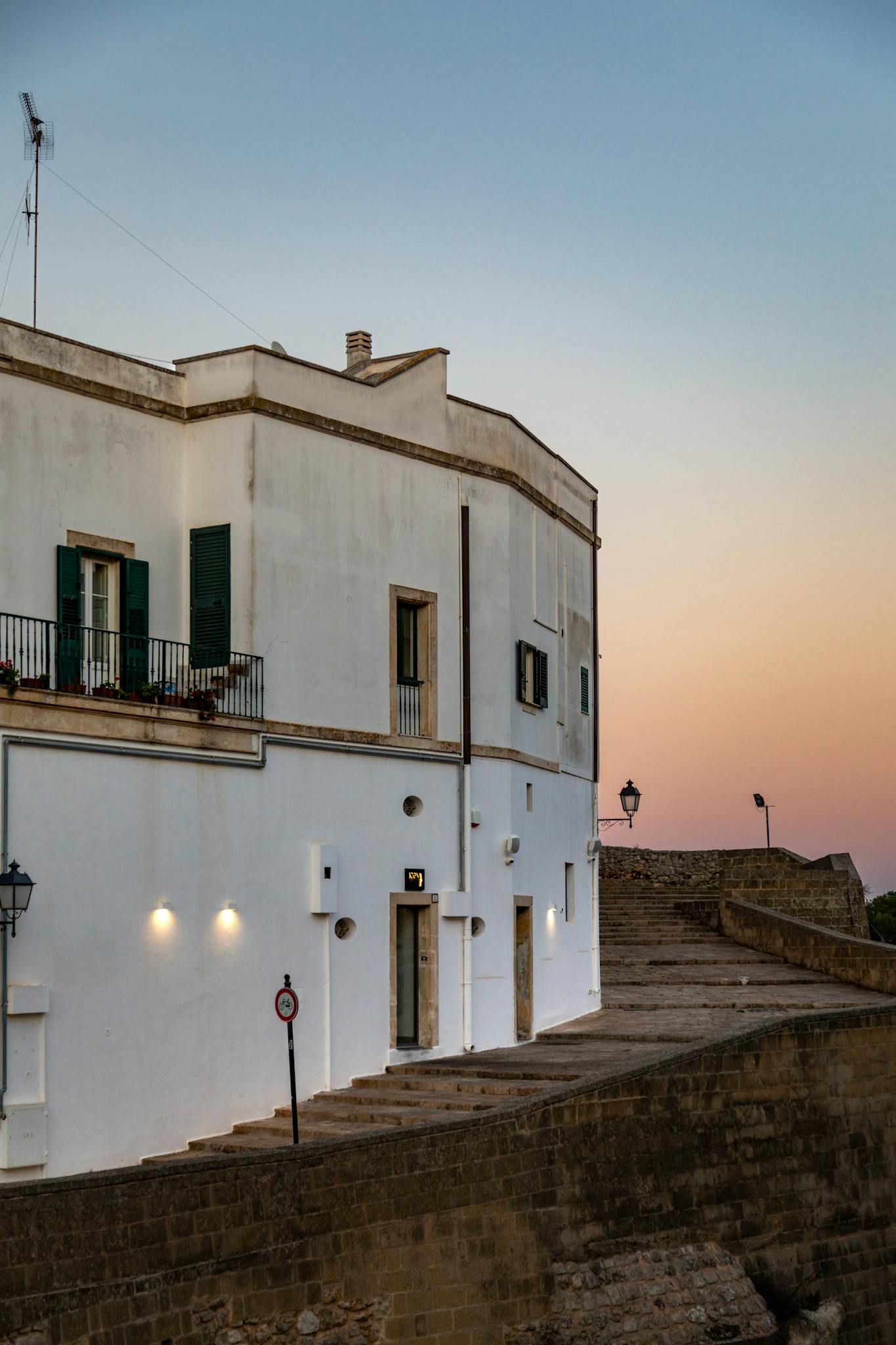 Charming evening view of historic architecture in Bari, Italy, with a serene sunset sky.