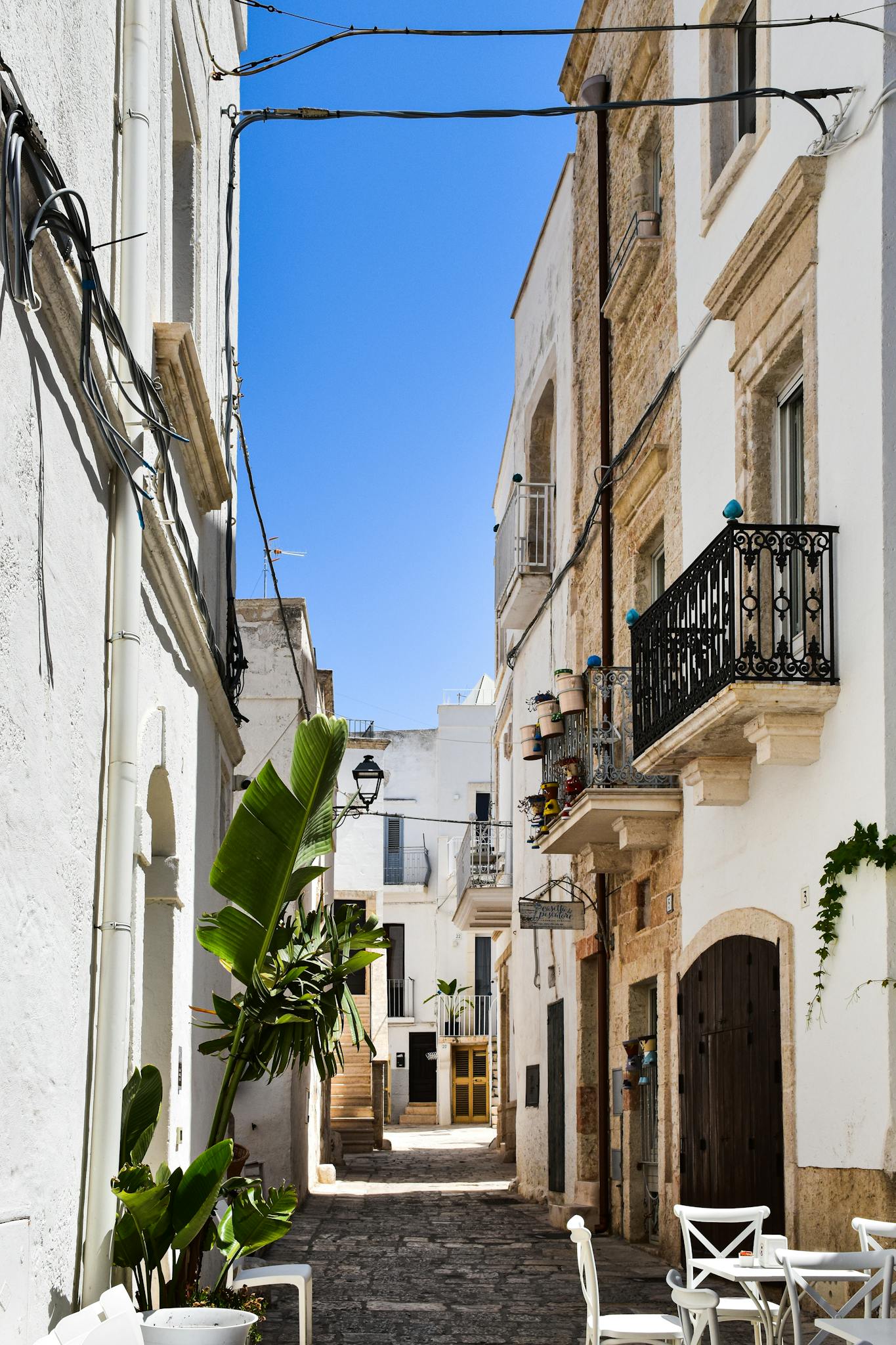 Discover the charm of a historic alleyway in Apulia, Italy, with its picturesque architecture.